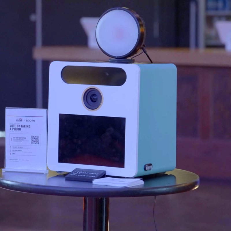 The Booth in white and teal on a cocktail table